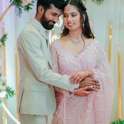 A happy couple shares a sweet moment during their engagement celebration. Their smiles and gentle embrace capture the joy of this special milestone.