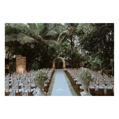A soft white dream for a Christian wedding. The aisle is lined with baby's breath, leading to a romantic floral arch, with Victorian vases adding a touch of classic elegance.