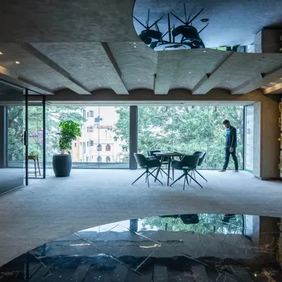 The bold and stylish Gala Showroom. The design uses reflections, dramatic lighting, and a dark, moody palette to create a sophisticated and immersive experience for visitors.