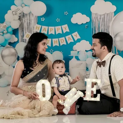 Happy First Birthday. We helped this family celebrate their son's big "ONE" with a custom birthday setup in our studio, complete with balloons and festive decorations for a memorable milestone photoshoot.