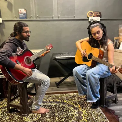A typical one-on-one guitar lesson in our HSR Layout studio. Our instructor guides a student through chords and techniques, providing personalized feedback to help her improve quickly.