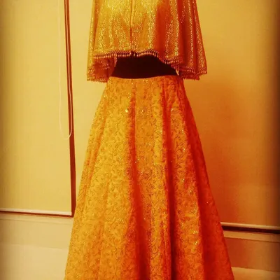 This golden cape-style lehenga is a classic that I've recreated many times on demand. The shimmering cape blouse paired with a flowing skirt is a showstopper, and seeing a happy customer wear it is the greatest reward.