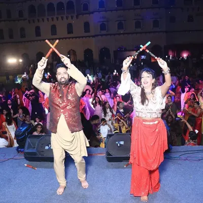 My partner Urvashi and I performing on stage at the 'City Dandiya Raas' event in Karnal. We love leading the crowd and sharing our energy with everyone.
