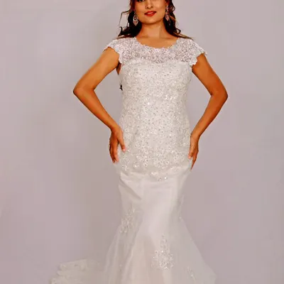 A stunning mermaid gown, fully embellished with intricate beadwork that sparkles with every movement. The cap sleeves and classic silhouette create a look of pure Hollywood glamour.