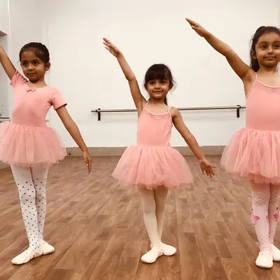 Three of our students showcasing their poise and confidence. Our program focuses on developing grace and proper form from the very first lesson, all while wearing the biggest smiles.