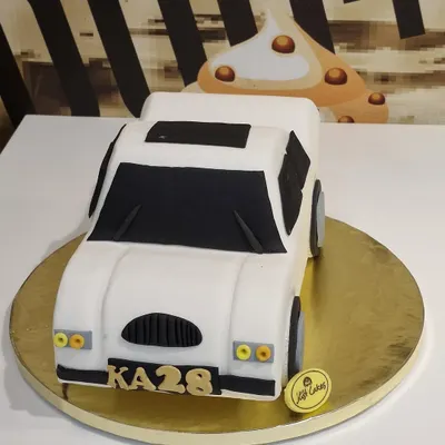 A sleek 2.5kg custom cake sculpted to look like a white car, complete with a personalized license plate.