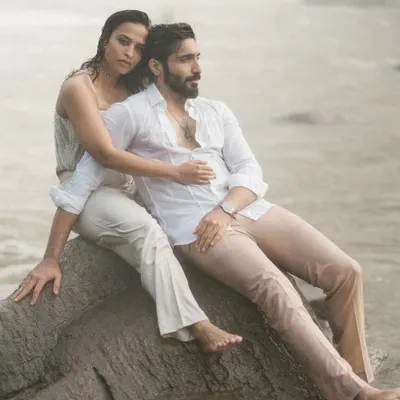 An intimate portrait set against the powerful mist of the Athirapilly waterfalls. The couple's gentle embrace and the raw, natural backdrop create a feeling of timeless romance and epic love.