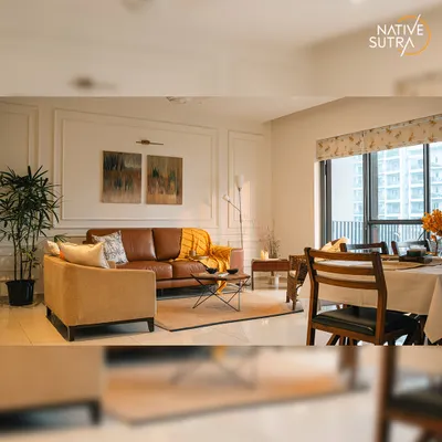 An overview of the open-plan living and dining area, designed to be bright, airy, and cohesive. The consistent color palette and classic wall mouldings unite the two zones, creating a spacious and harmonious environment.