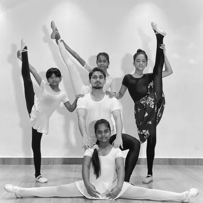 My advanced ballet students showcasing their flexibility and strength in a group pose. This demonstrates the results of dedicated training and practice in my classes.