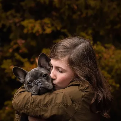 A moment of pure, gentle love. A girl gives her French Bulldog a sweet kiss on the head. This is the kind of candid, heartfelt image that I dream of capturing.