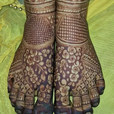 A stunning full-coverage foot mehndi design. The pattern is dense with floral and jaal work, perfect for a bride or for a grand festival celebration.