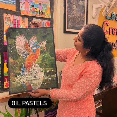I'm showcasing a student's impressive kingfisher painting done in oil pastels. We explore a wide range of mediums in the studio to help students find what they love.