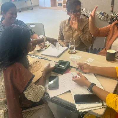 Teachers at DPS Hinjawadi engage in a hands-on activity during a 'Math from Scratch' workshop. The session is filled with laughter and collaboration, demonstrating that learning new teaching methods can be a joyful experience.