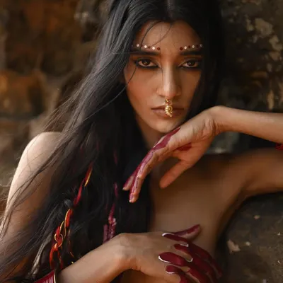 For this conceptual shoot, I created a dramatic reverse cat-eye and tribal-inspired dot work on the brow bone. The look is complemented by hand-painted red alta on the fingers, creating a raw and powerful visual.