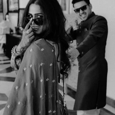 Partners in style, partners in crime. This playful black and white shot captures the cool, fun-loving dynamic of the couple, showing that wedding photos can be full of personality.