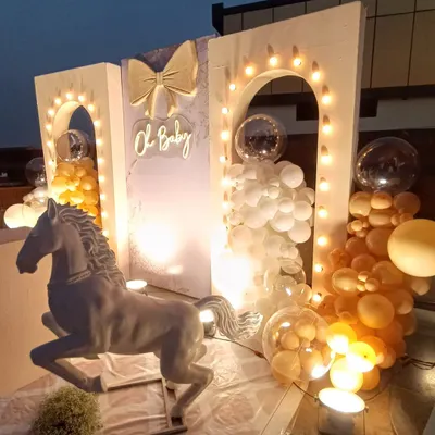 "Oh Baby, a little rider is on the way!" This elegant horse-themed baby shower features a beautiful backdrop with archways, string lights, and a neon sign. The white horse statue adds a unique and sophisticated touch to the celebration.