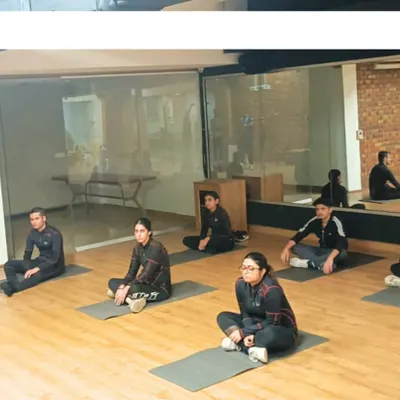 A group of rifle shooters participates in a training camp session, learning together in a focused environment. My programs, led by expert coaches like Deepali Deshpande, are designed to prepare athletes for national-level competition.