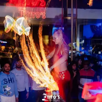 The party heats up with a spectacular fire performance at Tito's. I often incorporate live performers like fire dancers into my events to elevate the experience.