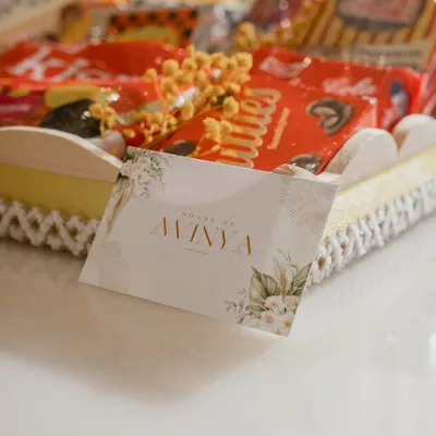 A close-up of our 90s Nostalgia hamper, showcasing the custom House of Avinya card. This box is filled with throwback treats like Coffee Joy, Rol-a-Cola, and Choki Choki.