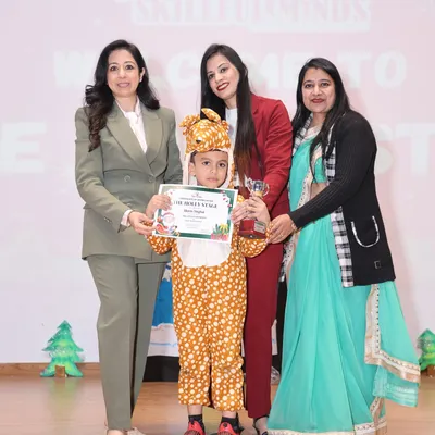A proud moment on stage at our Christmas show. One of our little performers, dressed as a reindeer, receives her award and certificate from our esteemed chief guests.