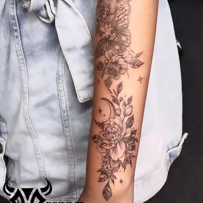 A beautiful and intricate floral sleeve featuring peonies, a crescent moon, and a deaths-head hawkmoth. This design combines elements of nature with celestial and gothic themes.