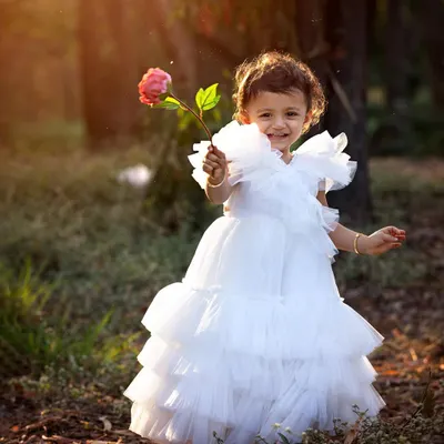A princess in the woods! The warm, glowing light of the golden hour makes outdoor portraits like this one feel so magical. This little girl's smile and her beautiful white dress are just perfect against the natural backdrop.