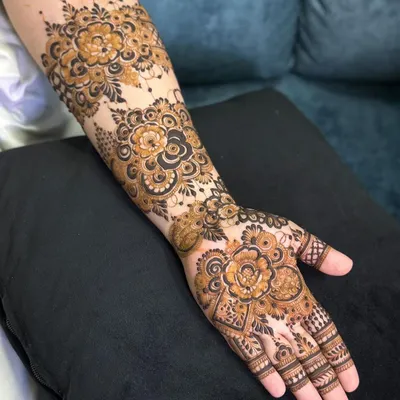 This design is a celebration of floral patterns, with large, detailed roses covering the back of the hand and forearm. The use of negative space makes the flowers pop.