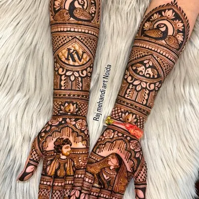 This is my specialty, turning your story into art. This custom bridal mehndi features detailed portraits of the couple on the palms, their initials "KV" elegantly placed on the forearms, and traditional peacock motifs, creating a design that is deeply personal and beautiful.