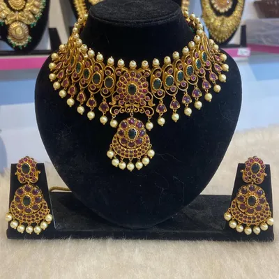 A beautiful kemp choker set with ruby-colored stones and pearl drops, perfect for adding a touch of tradition to any outfit.