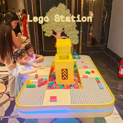 Our illuminated Lego Station is a hub of creativity for kids. The table features a large building surface and a central storage area filled with colorful blocks, with LED lights around the edge to make the experience even more engaging.
