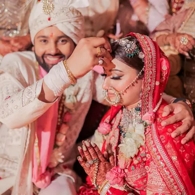 The sacred Sindoor moment. We captured the groom's smiling face as he applies the vermilion to his bride's forehead, a beautiful and significant ritual symbolizing their marriage.