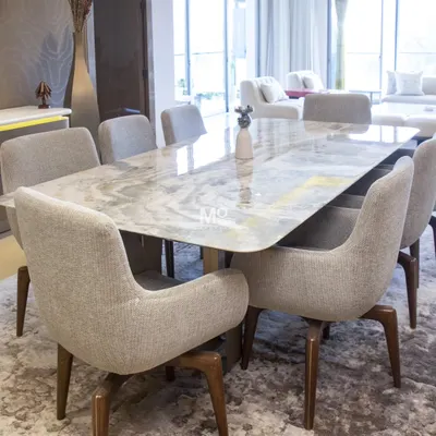 The Elysian Marble Dining Table and Sora Dining Chairs in a Suncity residence. The table's natural stone top and the chairs' sculpted backs create a setting of soft modernity and tactile richness.