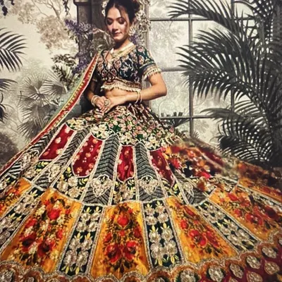 Our signature multi-color lehenga is a perfect choice for a Mehendi or Sangeet. The vibrant panels of yellow, red, and green with heavy embroidery ensure you stand out in every photo.