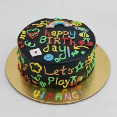A fun and colorful doodle cake for Vihangi's birthday. This eggless chocolate cake is covered in black frosting and decorated with vibrant, hand-piped doodles, just like a chalkboard.