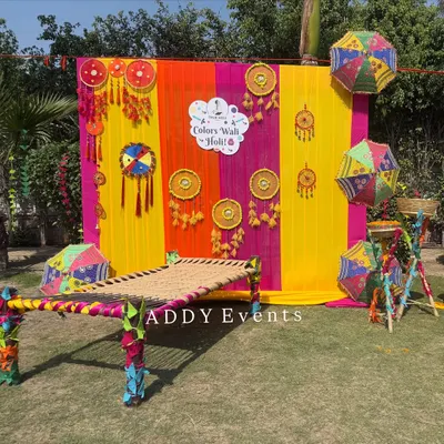 For a "Colors Wali Holi" party, we created this fun and traditional photo booth. It features a colorful draped backdrop, a decorated charpai (traditional woven cot), and festive hangings like dreamcatchers and umbrellas.