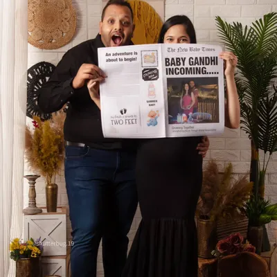 We love capturing pure excitement, and this custom newspaper announcement is a perfect way to do it. The couple's joyful expressions say it all: "Baby Gandhi Incoming!"
