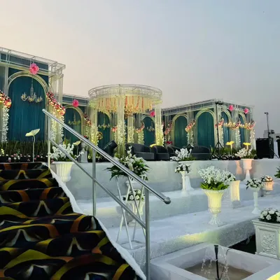 A closer look at the tiered white staircase and integrated fountains leading up to the main stage. This design adds depth and a sense of grandeur, making the approach to the stage an experience in itself.