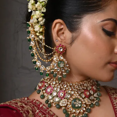 A close-up of one of my favorite bridal sets. The intricate work combines large Polki stones with drops of emerald and ruby-colored beads, complete with matching earchains for a truly regal look.