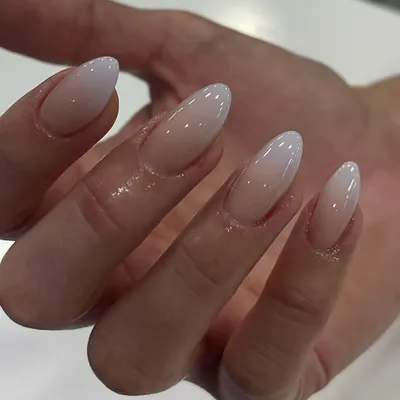 A perfect example of a classic 'baby boomer' ombré, with a seamless blend from a soft nude base to a milky white tip on almond-shaped nails.