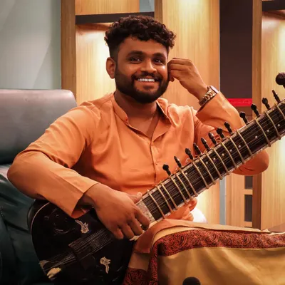 Just me, my sitar, and a smile. I believe in bringing a positive and collaborative attitude to every project I am a part of.