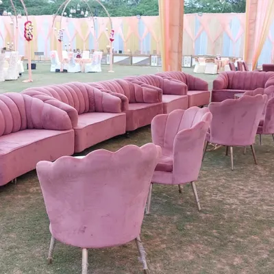 I can arrange comfortable and stylish seating for your outdoor events. This image shows a set of pink velvet sofas and scalloped chairs I provided for a lawn party.