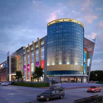 A design proposal for a large-scale shopping complex. The building's centerpiece is a cylindrical glass tower that serves as a visual anchor, designed to house flagship stores and create a modern, inviting hub for retail and social activity.