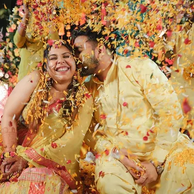 An explosion of flower petals and happiness during a 'phoolon ki haldi'. This shot perfectly captures the energy and vibrancy of the event.