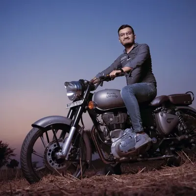 A pre-wedding portrait session with a Royal Enfield during the golden hour. These shoots are a great way to capture your personality in a relaxed, outdoor setting before the main events.