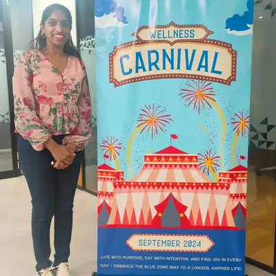 Proudly standing by our 'Wellness Carnival' banner. These events are designed to be vibrant, engaging, and packed with activities that make health feel like a celebration, not a chore. It's all about creating a positive and energetic atmosphere for employees.