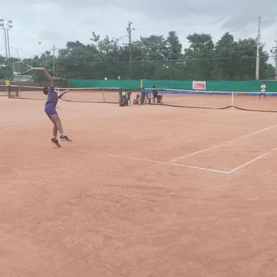 A young competitor executes a serve during the AITA TS7 U-14 tournament hosted at my academy.