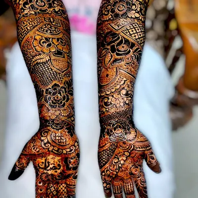A full-arm bridal design showcasing incredible detail. Notice the names of the bride and groom intricately woven into the pattern, a personal touch I love to add.