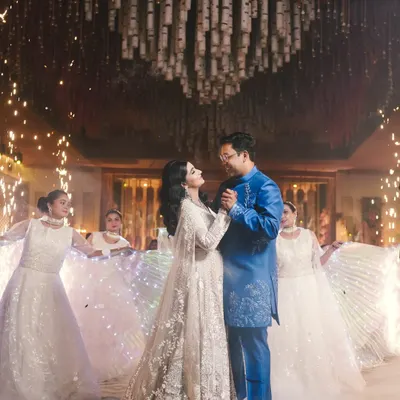 A fairytale first dance. The couple is surrounded by dancers in illuminated dresses and a shower of sparklers, creating a truly magical and cinematic moment for their reception.