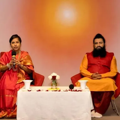 Maa Aditiji speaking during a Siddha Healing and Meditation event in Sydney, Australia. This photo captures the interactive nature of our Satsangs, where we share spiritual wisdom and answer questions from the audience.