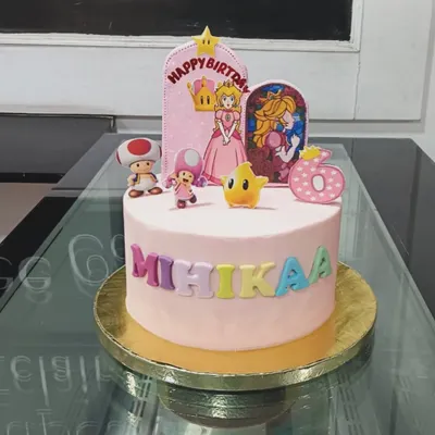 A delightful Princess Peach and Super Mario themed cake for a 6th birthday. This pink cake features fondant characters and colorful lettering to celebrate a special day.